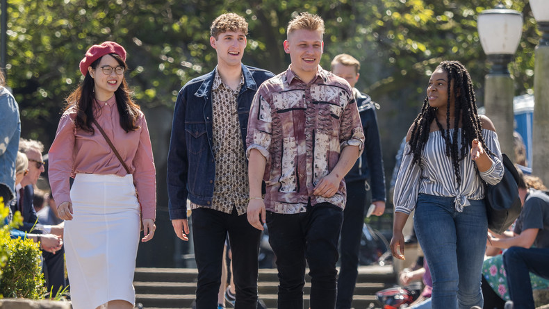 Students on the sunny University of East Anglia campus.