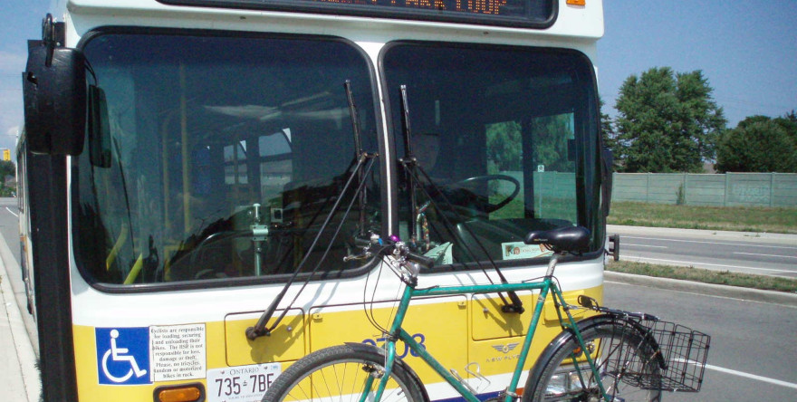 A public bus with a bike on its rack in Hamilton, Ontario.