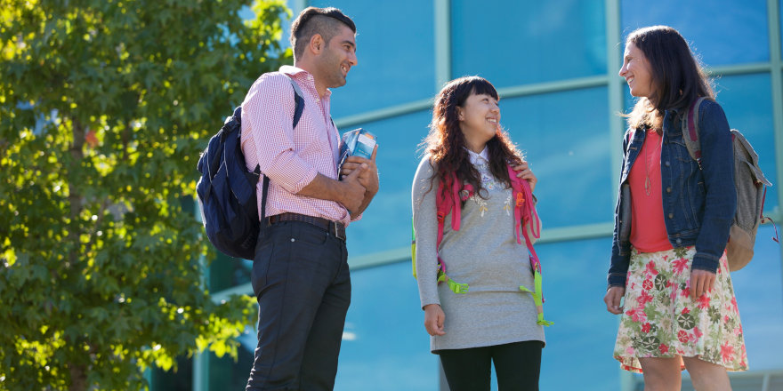 Students get together too chat on the sunny campus of Vancouver Island University.