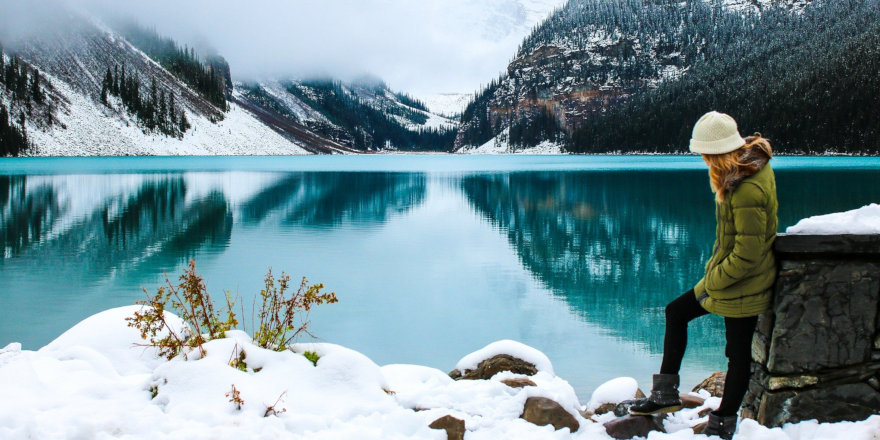 A student takes in the serene brilliance of a cerulean mountain lake.