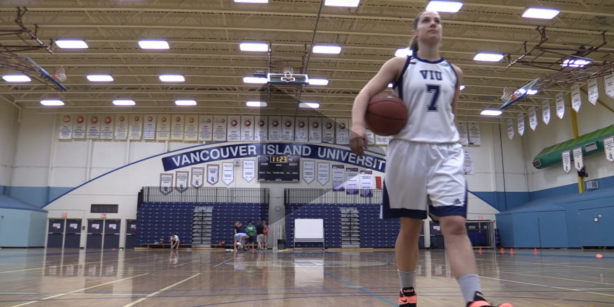 VIU Mariners athlete Jenna Carver strides confidently across the basketball court in this video still.
